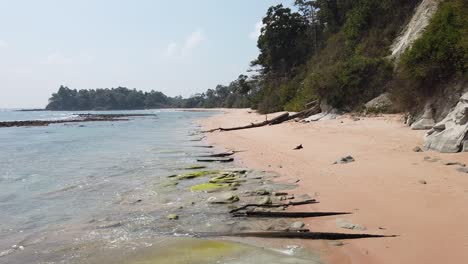 A-static-video-image-of-a-remote-beach-on-an-old-volcanic-island-in-the-Andaman-Nicobar-Island-chain-with-ancient-forests-and-white-sand-on-a-hot-sunny-day-in-the-dry-season