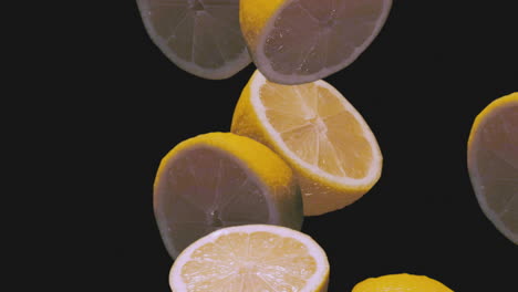 Frische-Saftige-Zitronen,-Die-In-Superzeitlupe-Auf-Schwarzem-Hintergrund-Fallen