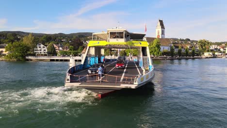 Close-aerial-drone-shot-of-car-ferry-Meilen-loading-cars-on-Lake-Zürich-in-Switzerland