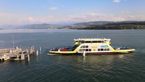 Aerial-drone-side-shot-of-car-ferry-Meilen-arriving-at-Meilen-on-Lake-Zürich-in-Switzerland