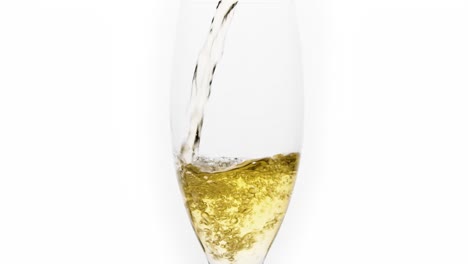 Mid-shot-of-white-wine-poured-in-slowmotion-in-a-glass