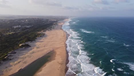 Aerial-view-to-Illovo-beach-in-South-Africa-with-Durban-in-horizon-and-waves-in-Indian-Ocean,-dolly-shot