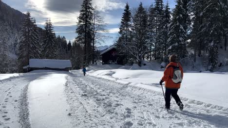 People-walking-in-Justistal-in-winter-full-of-snow-in-the-Bernese-Oberland-in-Switzerland