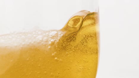 Macro-slowmotion-shot-pouring-beer-inside-a-glass-half-full
