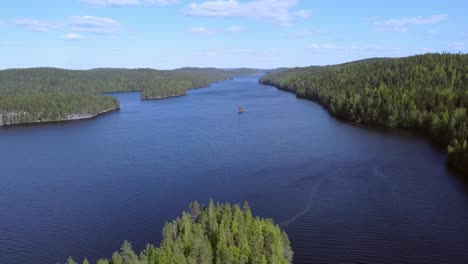 Aerial-view-of-lake-Isojarvi-during-summer-in-Isojarvi-National-Park,-Finland,-aerial-reversing-dolly-shot