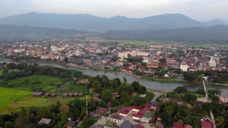 Aerial-dolly-in-over-Nam-Song-River,-Vang-Vieng,-Laos