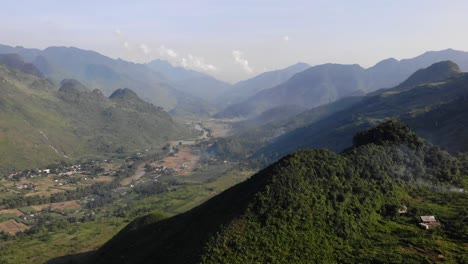 Slow-aerial-dolly-in-looking-down-at-the-valley-in-Ha-Giang,-Vietnam