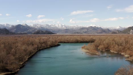 AERIAL---Lake-Skadar-and-chains-of-mountains-in-the-background,-Montenegro,-truck-right