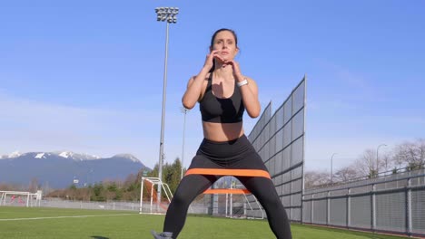 Walking-resistance-band-squats-young-athletic-woman