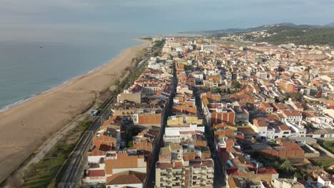 Aerial-drone-view-of-Malgrat-de-Mar-city-in-Spain-Maresme-tourist-town-beach-views