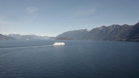 British-Columbia-Ferry-Services-in-Vancouver,-aerial-view-of-vessel-sailing-during-a-sunny-day-with-scenic-Canadian-mountains-landscape