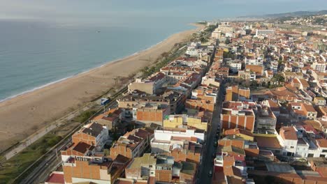 Aerial-drone-view-of-Malgrat-de-Mar-city-in-Spain-Maresme-tourist-town-beach-views-Santa-Susana-Pineda-province-of-Barcelona