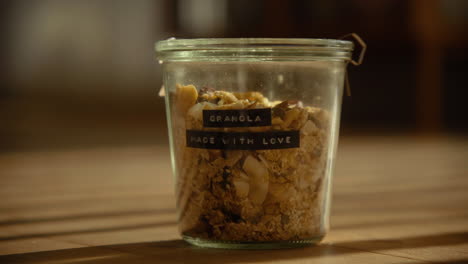 Homemade-granola-in-a-glass-container-in-sunlit-living-room