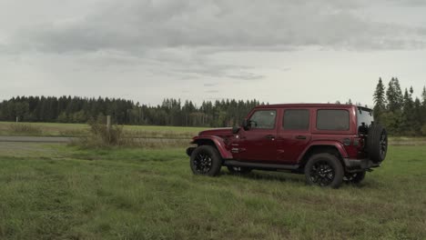 Panning-Drone-shoot-of-a-Red-Jeep-Wrangler-on-a-farm-in-4k