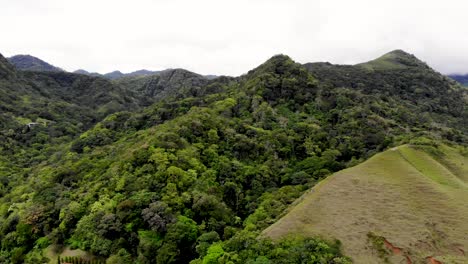 Ancient-volcanic-terrain-with-tree-covered-hills-at-Valle-de-Anton-crater-in-central-Panama,-Aerial-dolly-out-shot
