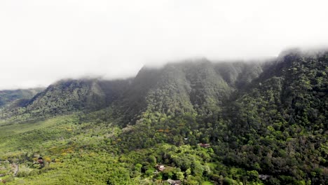 Valle-de-Anton-cloudy-volcanic-crater-wall-covered-by-forest-in-central-Panama,-Aerial-dolly-out-shot