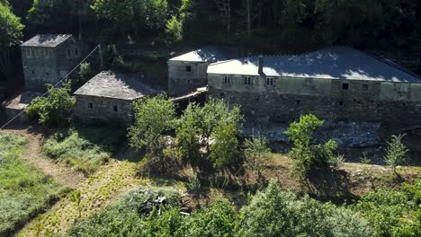 Aerial-shot-of-stone-houses-in-the-middle-of-the-nature