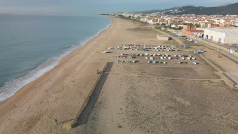 Malgrat-de-Mar-beach-in-Maresme-province-of-Barcelona-Spain-aerial-view-Fisherman's-boats-in-the-sand