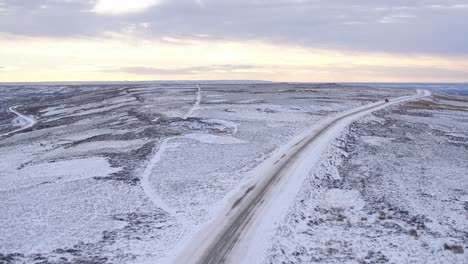 North-York-Moors,-road-near-to-the-Lion-Inn-Blakey-Ridge-covered-in-heavy-snowfall-difficult-driving-conditions-in-winter-snow---aerial-footage-dji-inspire-2-CLIP-2