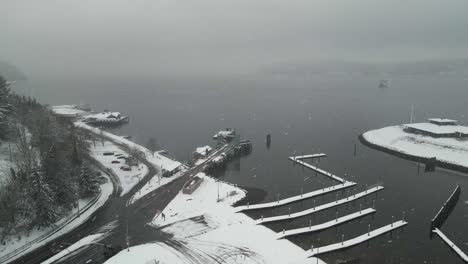 A-Washington-State-ferry-sails-through-fog-and-a-snowstorm-from-Vashon-Island-to-Tacoma,-aerial