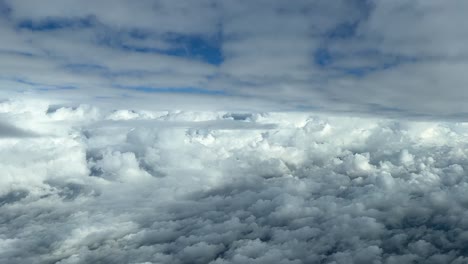 Aerial-view-from-a-cockpit-flying-between-layers-of-clouds-in-daylight