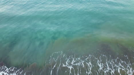 Drone-shot-of-waves-in-the-seashore
