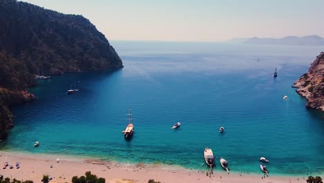Aerial-dolly-shot-of-paradisiacal-turkish-beach-during-sunny-day