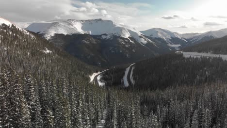Snow-capped-evergreen-trees-as-aerial-nears-Berthoud-Pass,-Colorado