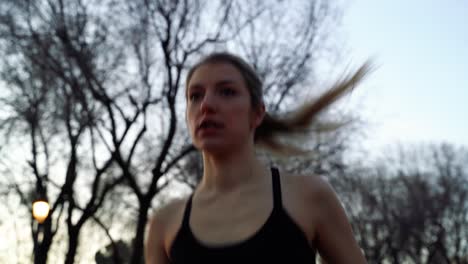 Caucasian-Active-Woman-Running-Through-City-Park,-Low-Angle-Close-Up