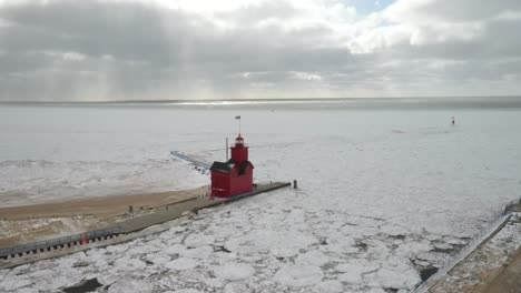 Holland,-Michigan-lighthouse-in-the-winter-at-Lake-Michigan-with-drone-fly-over