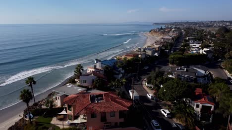 A-stunning-aerial-drone-shot,-flying-over-beautiful-beach-houses-towards-the-ocean,-Solana-Beach---San-Diego---California