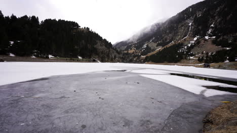 Frozen-mountains-altitude-lake-during-winter-season-in-val-de-nuria,-Spain-destination-for-adventurer-and-trekkers