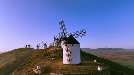 Beautiful-drone-shot-of-the-windmills-in-Consuegra,-Spain-on-sunny-day