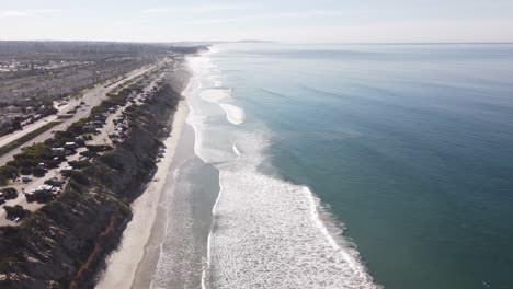 A-beautiful-aerial-drone-shot,-drone-descending-to-the-beach,-Carlsbad-State-Beach---California