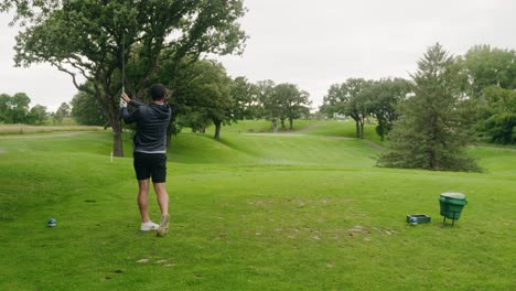 golfer-swinging-an-iron-and-hitting-a-golf-ball-on-a-par-3-hole
