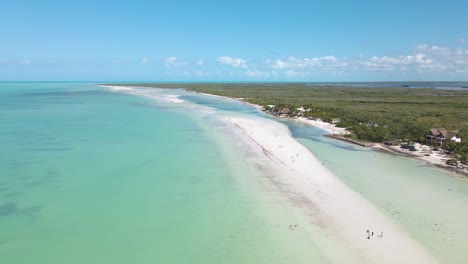 Wide-angle-drone-shot-off-the-coast-of-the-tropical-island-of-Holbox-located-in-the-Caribbean-sea-with-crystal-clear-turquoise-waters-and-white-sand-beaches-in-Mexico-shot-in-4k
