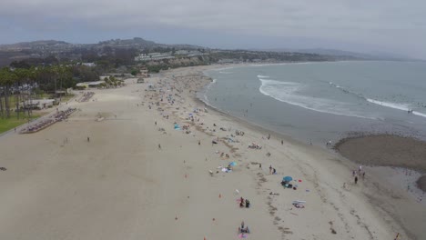 A-beautiful-aerial-drone-shot,-drone-descending-into-the-beach,-Dana-Point---Orange-County---California