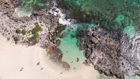 Bird's-eye-view-drone-shot-of-a-breathtaking-view-from-above-of-a-rock-pool-located-on-the-coastline-of-Cozumel,-Mexico-in-the-Pacific-ocean-in-4k