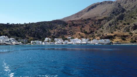 View-from-a-boat-leaving-the-Cretan-village-of-Loutro-famous-for-its-whitewashed-houses-and-for-being-embedded-in-mountains
