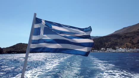 Greek-flag-on-a-boat-leaving-Loutro
