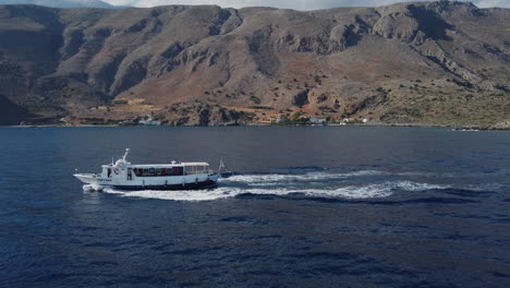 Boat-pitching-in-the-Cretan-South-Seas-off-a-mountainous-and-volcanic-landscape