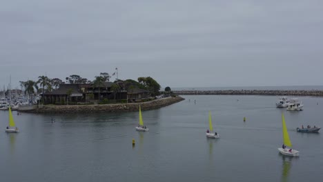 A-beautiful-aerial-drone-shot,-drone-circulating-sailboats,-Dana-Point---Orange-County---California