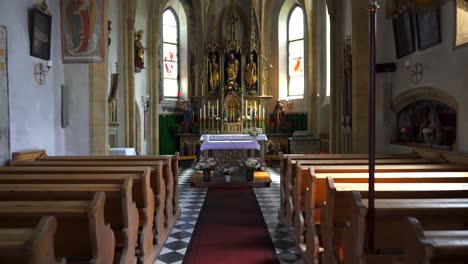 Moving-dolly-shot-of-the-interior-of-a-small-gothic-Roman-catholic-church,-the-Chiesa-di-Santa-Maddalena-in-Vierschach,-Italy