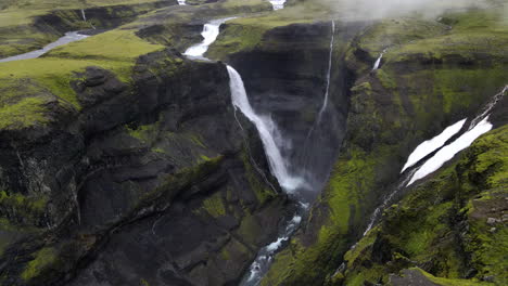Big-waterfall-Haifoss-hidden-in-the-mountain-gorge-of-Fossárdalur,-in-Iceland