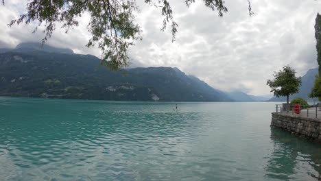 Unrecognizable-person-paddling-on-SUP-board-on-serene-Brienz-lake,Switzerland