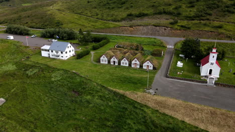Aerial-shot-approaching-towards-the-turf-houses,-historical-in-Iceland