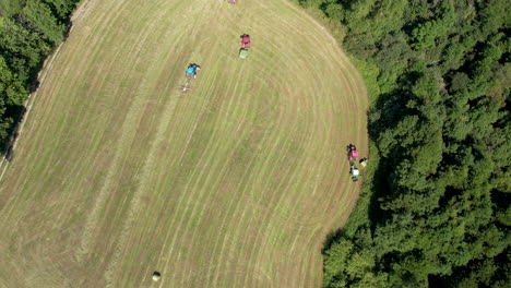 Aerial-Looking-Down-At-View-Of-Tractors-Working-Across-Field-In-Chmielno