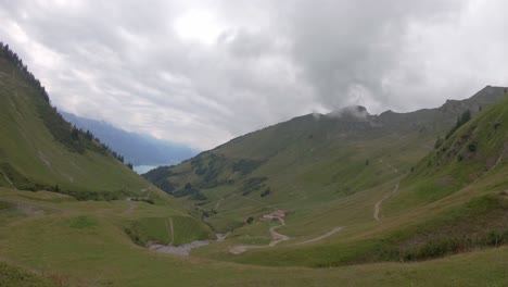 Serene-alpine-valley-with-view-on-Brienz-lake,-Switzerland-on-misty-summer-day