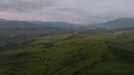 Panoramic-View-Of-Vast-Fields-Under-Cloudy-Sky-In-Samtskhe-Javakheti,-Southeast-Of-Upper-Vardzia-In-Georgia---drone-shot