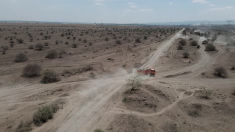 a-big-truck-drives-over-the-dusty-sand-tracks-in-kenya